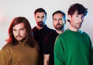 Chris 'Woody' Wood, Kyle Simmons, Will Farquarson and Dan Smith of Bastille look moodily at camera in press shot.