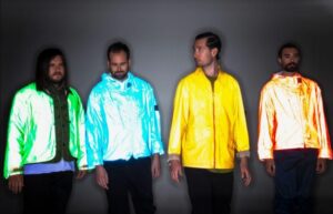 Bastille in brightly coloured coats, in press shot.