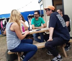 Sally Churchward interviewing Dan Smith, Woody, Kyle Simmons and Will Farquarson of Bastille backstage at Victorious Festival.