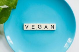 The word vegan spelt out across a blue plate.